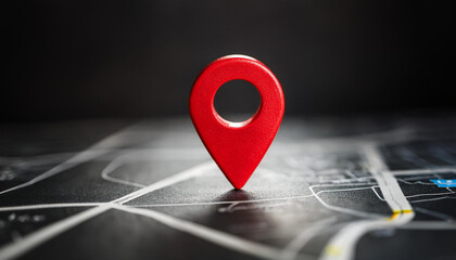 Red location marker on dark background. Navigational search. Close-up. Space for text.