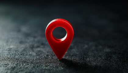 Red location marker on dark black background. Navigational search. Close-up.
