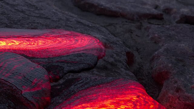 Molten Lava Rivers Carve Paths Through Dark Volcanic Rock