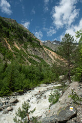 Melt waters of the Becho Glacier. Water flowing from the glacier on Ushba mountain. 
Dolra River in Becho Valley with panoramic views of Ushba Mountain. River photos taken with long exposure.