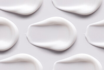 cosmetic smears of creamy texture on gray background