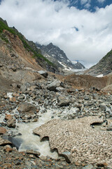 Melt waters of the Becho Glacier. Water flowing from the glacier on Ushba mountain. 
Dolra River in Becho Valley with panoramic views of Ushba Mountain. River photos taken with long exposure.