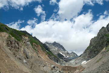 Melt waters of the Becho Glacier. Water flowing from the glacier on Ushba mountain. 
Dolra River in Becho Valley with panoramic views of Ushba Mountain. River photos taken with long exposure.