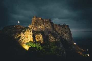 Aerial side view illuminated at night Agarani or Kojori, Azeuli, Kor Ogli Fortress. Georgian feudal fortress near Tbilisi visit destination by Kojori village in Kvemo Kartli region