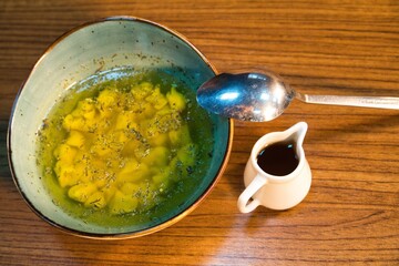 Yellow Soup in Blue Bowl With Spoon and Gravy