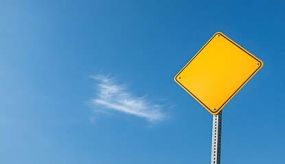 A photo of a yellow blank traffic sign on a blue sky background, isolated with space for text or design. Taken with a wide angle lens in daylight.