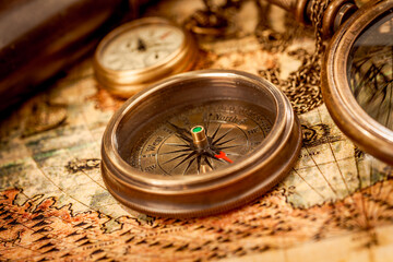 Vintage style travel and adventure. Vintage old compass and other vintage items on the table.