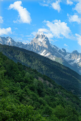 Obraz premium Georgia trekking routes. Magnificent Georgian mountains. Snowy and green mountains of Georgia. Svaneti mountains. Mountain landscapes in bloom in spring.