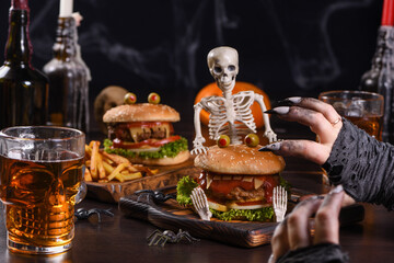 The witches hands want to grab the Monster Burger on the sitting skeleton. Perfect Halloween Party appetizer