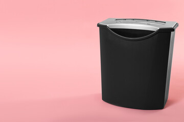 Paper shredder with basket on pink background, space for text