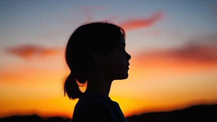 Contemplating the Cosmos: Student Engaged in Astronomy Learning Watches Sunset Silhouette for Earth's Rotation Concept.