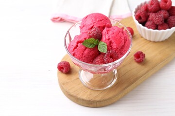 Delicious raspberry sorbet, mint and fresh berries on white wooden table, space for text