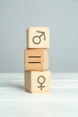 Gender equality concept. Cubes with male and female symbols on white table
