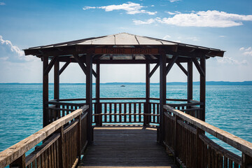 Fototapeta premium Picturesque view of a wooden gazebo on Lake Garda, Italy