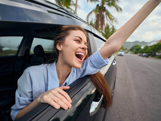 Woman in car, back seat a joyful woman sits in the back seat of a car, her arms raised high,...
