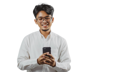 A joyful young Asian man smiles while using his cell phone, with a simple Transparent background enhancing the scene.