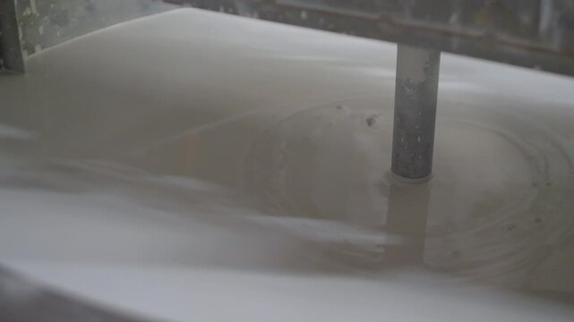 Interlocking tiles making machine. Mixer use in process of tiles manufacturing. Equipment for the production of artificial tile. Slip or clay slurry 