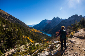 Young hiker woman in autumn in Aiguestortes and Sant Maurici National Park, Spain