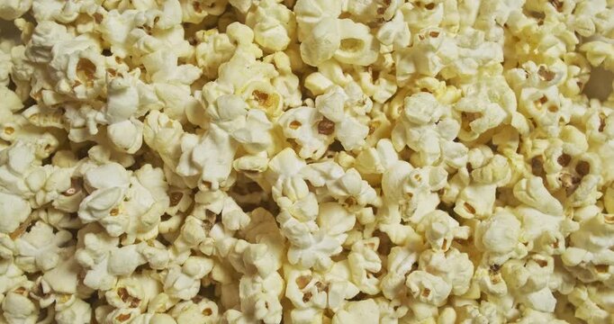Rotation cheese popcorn top view, seamless loop. Popcorn shop, cinema background