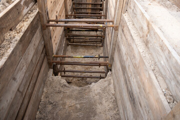 repairing underground utilities, essential infrastructure, protecting electrical wires in trench, repairing urban communications, conducting electrical networks