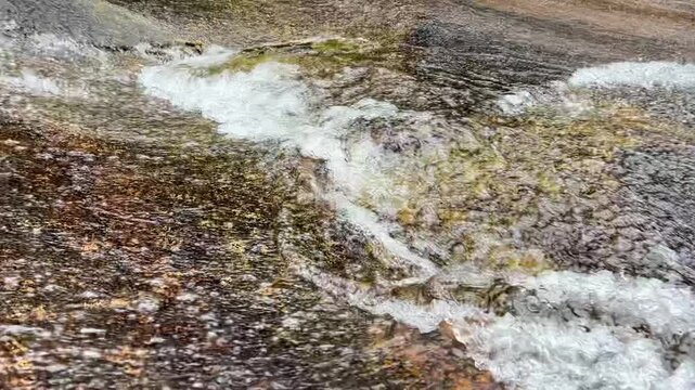 River water stream on big rock