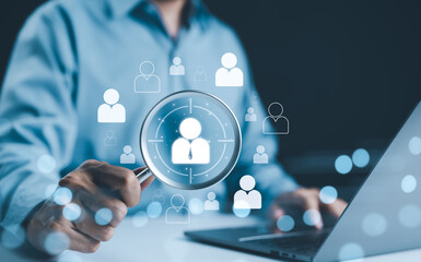 HR, Human Resources Concept. HR professional holding magnifying glass with icons of a person,...
