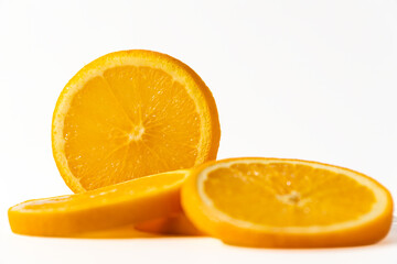 A pile of fresh orange slices, isolated on white background