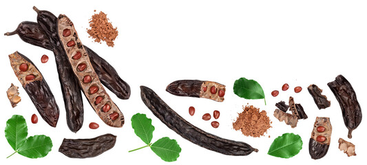 Ripe carob pods and bean isolated on white background. Top view with copy space for your text. Flat lay