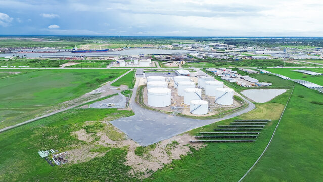 Port of Brownsville ship harbor with fuel terminals complex, solar panel field, liquids storage capacity tanks for streamlined oil, gasoline, diesel, jet fuel, petroleum products, Texas, aerial