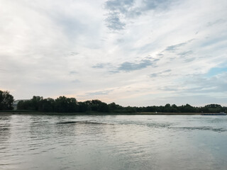 A calm lake with a cloudy sky in the background