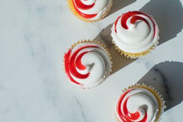 Tasty cupcakes with cream cheese frosting. Homemade muffins top view