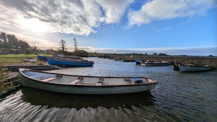 Fototapeta premium Old wooden fishing boats in Corrib lake at Annaghdown pier, county Galway, Ireland, nature background