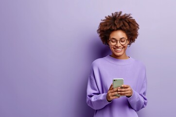 Smiling young black woman girl in purple shirt posing isolated on purple wall background studio portait.