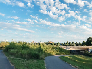 A bridge spans a river with a green field on either side