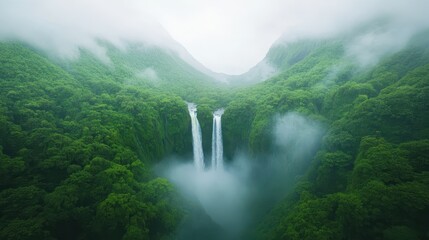 A lush green forest with two waterfalls, one of which is a large