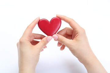 Woman holding red heart on white background, closeup