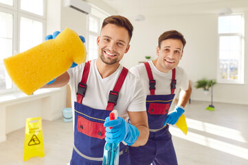 Portrait featuring two happy man, dedicated cleaners from the service staff. Dressed in gloves, these individuals radiate happiness as they contribute to the cleanup and housekeeping efforts.