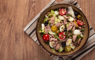salad with canned tuna, vegetable salad with quail eggs, lettuce, red onion , cherry tomatoes , olives, keto food, healthy food, homemade, no people