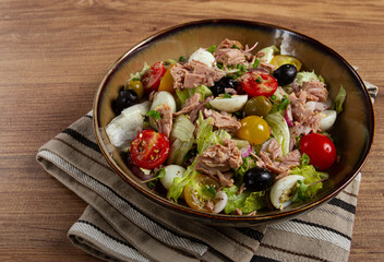 salad with canned tuna, vegetable salad with quail eggs, lettuce, red onion , cherry tomatoes , olives, keto food, healthy food, homemade, no people