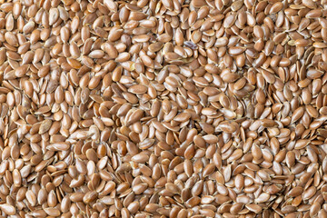 Fototapeta premium Brown flax seeds, close-up. Backgrounds and textures. Food and drinks. Proper nutrition.