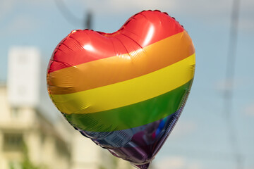 A heart-shaped balloon in rainbow colors at the LGBT community pride parade.