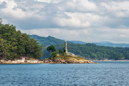 Lighthouse of the Tambo Island as seen from a boat in the Ria de Pontevedra in Galicia, Spain. Formerly a Naval Military School base, since 2022 it serves as a natural and cultural destination.