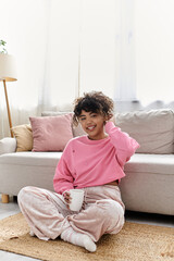 A young woman enjoys a peaceful moment while sipping a warm drink at home.
