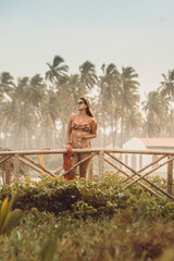 Beautiful brunette brazilian female model posing in front of Church at the beach in Sao Miguel dos Milagres, Brazil