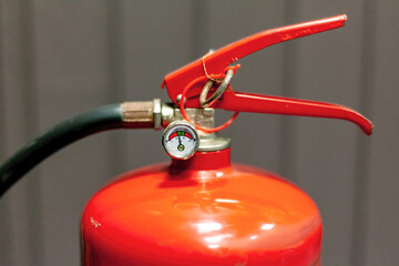 Classic red fire extinguisher handle and pressure dial gauge meter, safety pin, object top valve detail, extreme object detail extreme closeup, nobody. Repair, service maintenance abstract concept