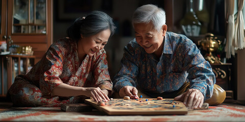 Elderly Asian couple playing traditional board game on the floor, surrounded by cherished possessions.