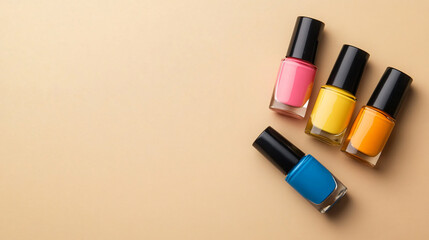 Obraz premium Colorful Nail Polishes in Bottles on Beige Background