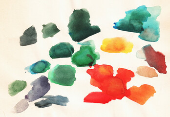 Colorful watercolor paint blobs on textured paper in a creative workspace during a bright afternoon