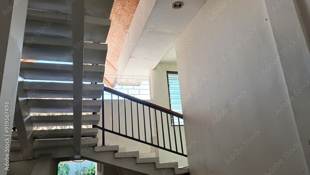 Poster a staircase with a railing and a window above it