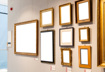 Lots of empty blank cut out white gold painting frames hanging on a wall inside a modern museum or art gallery generic interior, many paintings on one wall wooden panels, top lighting nobody no people